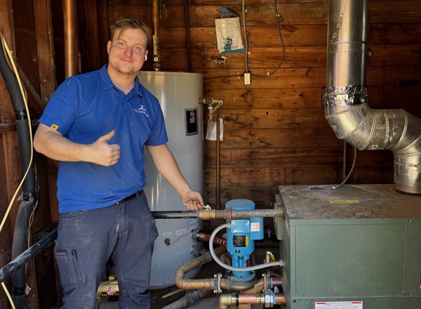 Plumber inspecting residential boiler setup
