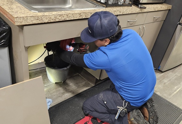 Plumber repairing garbage disposal