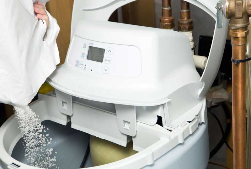 Water softener being refilled with salt
