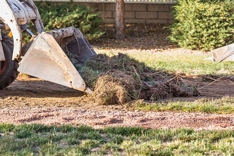 Land yard clearing with loader bucket